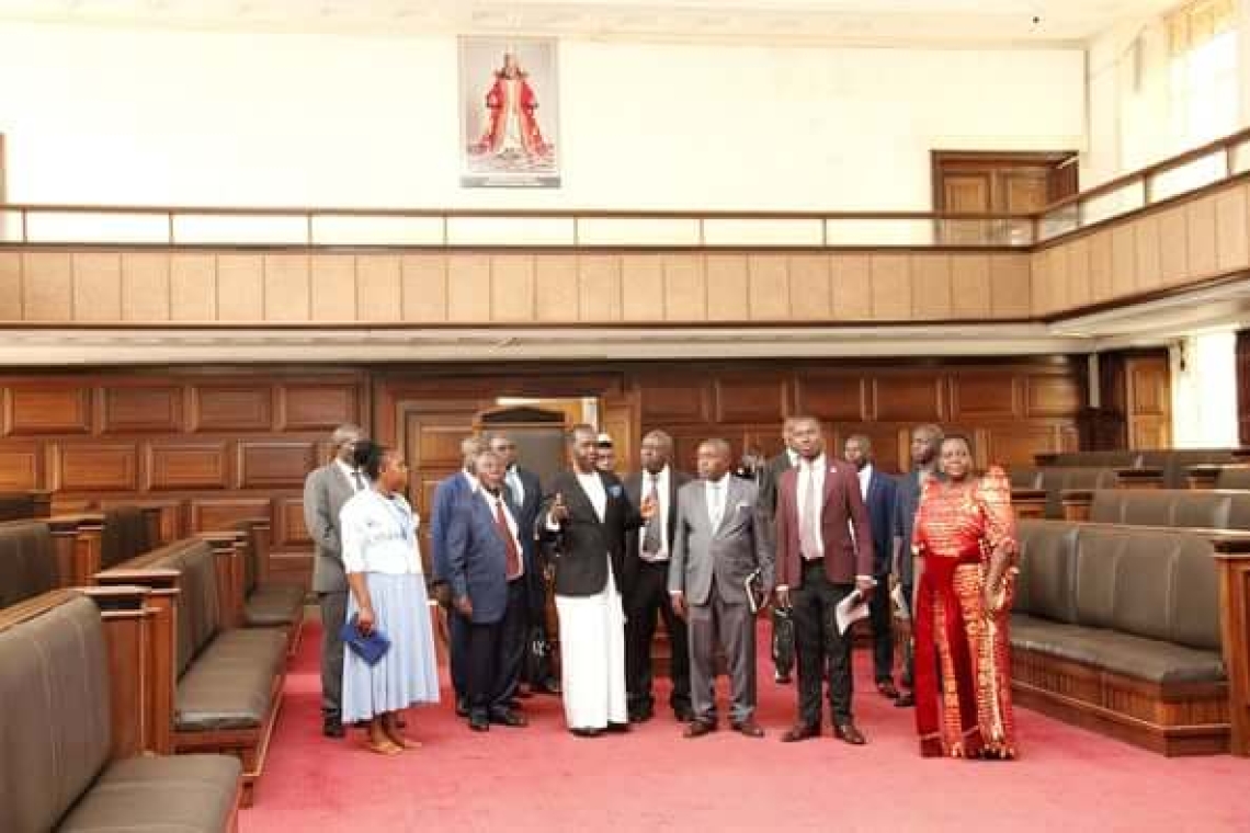 Guests from the Rwenzururu Kingdom are guided by Hon. Mugumbule through the Buganda Lukiiko Hall